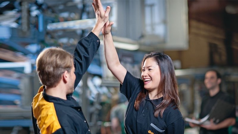 Two Continental employees give each other a high five.