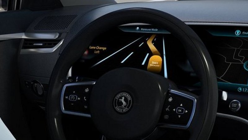 Close up of car cockpit with large display on dashboard.