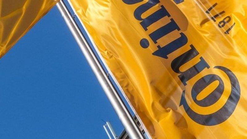 Four hoisted flags with Continental logo waving in the wind.